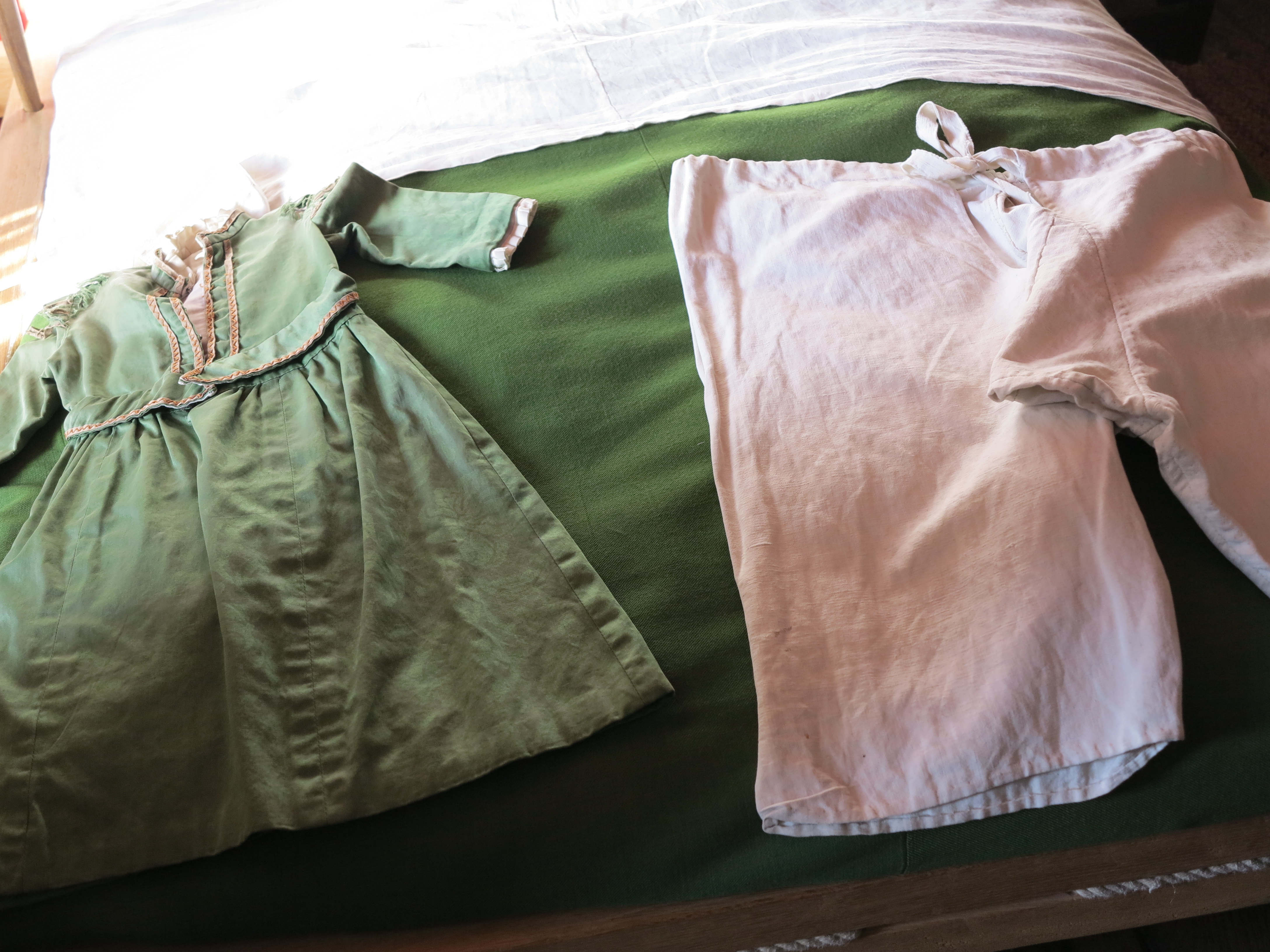 Children clothes on display in the bedroom of Shakespeare's Birthplace